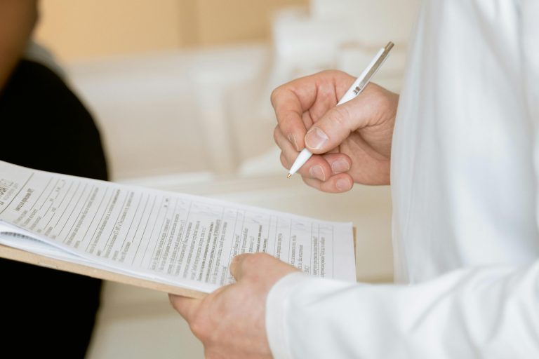 Orthopaedic physician reviewing documents with the help of a QME management company to streamline practice operations.