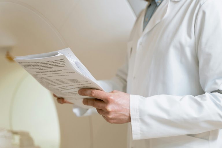Doctor discussing fitness evaluation results with an employee in an office setting, symbolizing workplace health assessments.